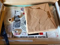 Full box view showing board insert, tape, triangles, ruler, envelope