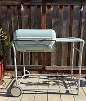 Front angled view of Spark One grill showing body color, side shelf, cart frame and wheels