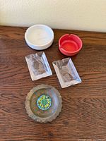 Group shot of all five ashtrays on wood surface