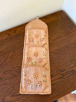 Full view of three-pocket wall mail sorter on table