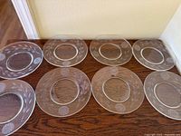 All eight clear glass plates displayed edge to edge