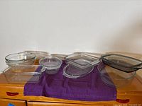 All nine glass bakeware pieces arranged on surface