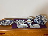 Group shot of all seven blue and white dishes on surface