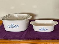 Large and small Cornflower Blue casseroles side by side, lid on large dish