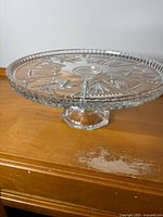 Side view of crystal pedestal cake tray showing overall profile and stem