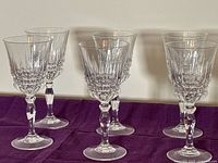 All six crystal wine glasses standing on surface