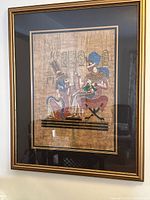 Full view of framed Egyptian papyrus print on wall