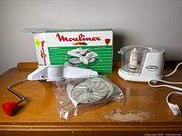 Full lot showing Moulinex box, slicer parts in bag and Traditions processor