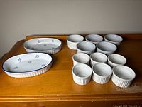 Full set of ramekins and oval baking dish on table