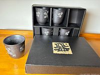 set of six cups in original box, one displayed separately