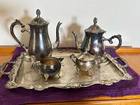 Full view of five-piece silver-plated set on tray