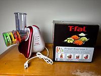 Appliance with five cone attachments installed and box beside