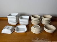 Overall view showing stacks of square plates and round bowls