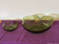large and small green glass bowls front view