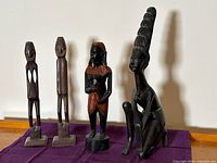 All four wooden sculptures displayed together