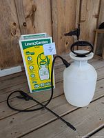 Sprayer with hose and wand alongside original box