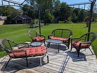 Full set on deck showing two armchairs, loveseat, coffee table, side table with cushions