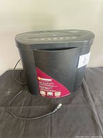 front view of ID Armor shredder showing label, power cord, overall condition