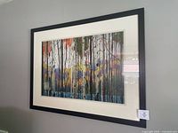 Full view of framed colourful trees print on wall