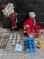 Lot overview showing two Santa dolls, three ornament sets, snow globe