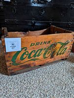 Side view showing "Drink Coca-Cola" script and overall crate