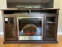 Front view of entire console with fireplace insert and TV on top