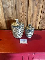 Both sweetgrass lidded baskets with lids on