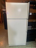 Front view of closed Kenmore fridge showing exterior color and wear