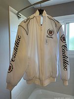 Front view of white Cadillac jacket on hanger