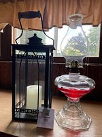 Both lanterns side by side on tabletop showing scale, shape and included candle
