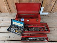 Overall lot: red toolbox open with trays and loose tools displayed