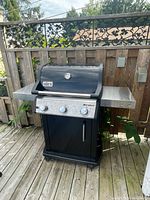 Front view of Weber Spirit grill with side shelves extended