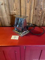 Front view of chrome Westinghouse toaster showing compact form and braided cord