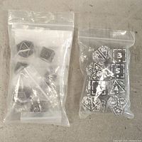 Both sealed bags of dice