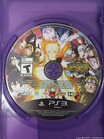 Front of PS3 game disc showing label art and T ESRB rating inside purple case