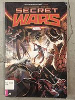 Front cover of Marvel "Secret Wars" graphic novel showing title artwork and overall wear