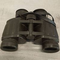 Front view showing full binocular body and strap