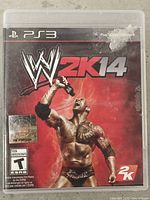 Front of PS3 case showing WWE 2K14 cover art