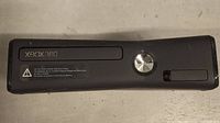 Front view of black Xbox 360 S console