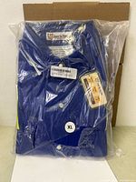 Front view of sealed blue flame-resistant jumpsuit package