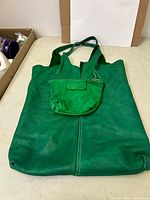 Front view of green leather tote bag with attached pouch