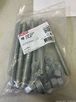 Front view of sealed bag showing threaded rods, nuts, washers