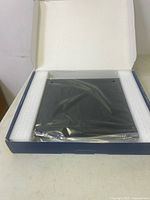 Insignia laptop cooling mat sealed in plastic inside foam-lined box