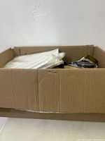 Overall view of cardboard box with mixed new items