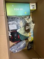 Top view showing Poo Gel box, massage pillow, plush and small cartons