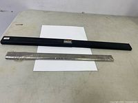 Blade pair and black holder on table