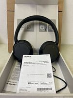 Headphones in box with manual visible