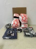 Full lot showing boxing gloves, banner package, hockey tape roll, bike bottle cage, hand wraps box