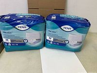Front view of both sealed TENA ProSkin underwear packs