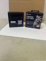 Tractive Cat Mini device in open packaging beside retail box